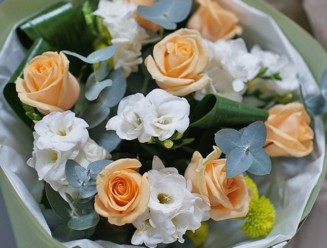 Bouquet of white freesias and cream roses photo
